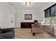Modern office featuring a sleek desk, comfortable chair, and natural light from the large window at 45 Hamilton Way, Youngsville, NC 27596