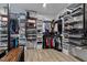 Walk-in closet with custom shelving and storage solutions for clothes, shoes, and accessories at 45 Hamilton Way, Youngsville, NC 27596