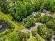 Gorgeous aerial view of a home surrounded by lush greenery and mature trees near a pond at 4513 Touchstone Forest Rd, Raleigh, NC 27612