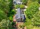 Aerial shot of home featuring a deck, backyard, and mature trees at 4513 Touchstone Forest Rd, Raleigh, NC 27612