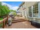 Inviting back deck featuring wooden railing, an outdoor dining set, and a relaxing rocking chair at 4513 Touchstone Forest Rd, Raleigh, NC 27612