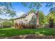 Spacious backyard with a deck, lush lawn, and privacy fence at 4513 Touchstone Forest Rd, Raleigh, NC 27612