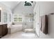 Bright bathroom featuring a glass shower, garden tub, and ample natural light at 4513 Touchstone Forest Rd, Raleigh, NC 27612
