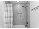 Modern bathroom with tiled shower, niche, and shower curtain at 4513 Touchstone Forest Rd, Raleigh, NC 27612