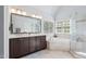 Luxury bathroom with double sink vanity, separate shower, and soaking tub near windows at 4513 Touchstone Forest Rd, Raleigh, NC 27612