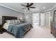 Cozy bedroom showcases a ceiling fan and a connecting door to the bathroom at 4513 Touchstone Forest Rd, Raleigh, NC 27612