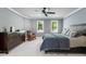 Comfortable bedroom featuring a ceiling fan, two windows, and soft carpeting at 4513 Touchstone Forest Rd, Raleigh, NC 27612