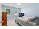 Well-lit bedroom features blue walls, two windows, and plush carpeting at 4513 Touchstone Forest Rd, Raleigh, NC 27612