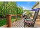 Relaxing deck features outdoor seating, a grill, and views of the lush backyard at 4513 Touchstone Forest Rd, Raleigh, NC 27612