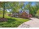 Beautifully landscaped home exterior with a well-manicured lawn and mature trees at 4513 Touchstone Forest Rd, Raleigh, NC 27612