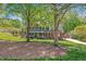 Two-story brick home with green lawn, mature trees, and a charming front porch at 4513 Touchstone Forest Rd, Raleigh, NC 27612