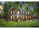 Charming red brick two-story home with a welcoming front porch and well-maintained landscaping at 4513 Touchstone Forest Rd, Raleigh, NC 27612