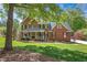 A two-story brick home with a charming front porch at 4513 Touchstone Forest Rd, Raleigh, NC 27612