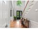 Inviting foyer boasts hardwood floors, a staircase, large arched window, and elegant columns at 4513 Touchstone Forest Rd, Raleigh, NC 27612
