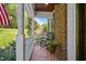 Charming front porch featuring brick flooring, rocking chair, and view of the landscaped yard at 4513 Touchstone Forest Rd, Raleigh, NC 27612