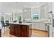 Bright and airy kitchen with an island, modern appliances, and access to a dining area, great for entertaining at 4513 Touchstone Forest Rd, Raleigh, NC 27612