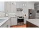 Well-equipped kitchen with stainless steel appliances, white cabinets, and a gas range at 4513 Touchstone Forest Rd, Raleigh, NC 27612