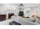 Inviting living room featuring a fireplace, plush carpeting, a large sectional, and access to a sunroom at 4513 Touchstone Forest Rd, Raleigh, NC 27612