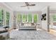 Bright living room featuring many windows, hardwood floors, modern decor, and white trim at 4513 Touchstone Forest Rd, Raleigh, NC 27612