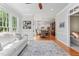 Open concept living area with hardwood floors, comfortable white seating, and views of the backyard at 4513 Touchstone Forest Rd, Raleigh, NC 27612