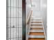 White and wood staircase with glass-paned door at 4513 Touchstone Forest Rd, Raleigh, NC 27612