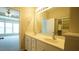 Bathroom with double sinks, neutral walls, and access to the closet at 4517 Pale Moss Dr, Raleigh, NC 27606