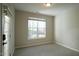 Neutral bedroom featuring a large window and door, creating a bright and airy space at 4517 Pale Moss Dr, Raleigh, NC 27606