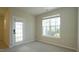 Neutral bedroom with a door to the backyard, featuring carpet and lots of light at 4517 Pale Moss Dr, Raleigh, NC 27606