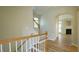 Inviting entryway featuring wood stairs, white railing and luxury vinyl plank flooring at 4517 Pale Moss Dr, Raleigh, NC 27606