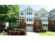 Charming townhome featuring a brick facade, attached garage and colorful landscaping at 4517 Pale Moss Dr, Raleigh, NC 27606