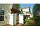 Exterior view of townhomes showing rear patios and upper balconies at 4517 Pale Moss Dr, Raleigh, NC 27606