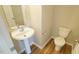 Well-lit half bath with pedestal sink and modern fixtures, perfect for guests at 4517 Pale Moss Dr, Raleigh, NC 27606