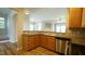 Eat-in kitchen featuring stainless steel appliances, hardwood cabinets and luxury vinyl plank flooring at 4517 Pale Moss Dr, Raleigh, NC 27606