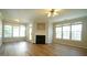 Spacious living room filled with natural light, a ceiling fan, and a cozy fireplace at 4517 Pale Moss Dr, Raleigh, NC 27606
