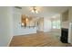 Open concept living space with kitchen, fireplace, and archway to other rooms at 4517 Pale Moss Dr, Raleigh, NC 27606