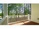 Relaxing side porch with white railing providing beautiful view of surrounding trees and greenery at 4517 Pale Moss Dr, Raleigh, NC 27606