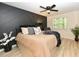 Serene bedroom with stylish accent wall, large window, and neutral decor with an overhead ceiling fan at 505 Gooseneck Dr # B1, Cary, NC 27513
