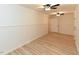 Spacious room with laminate flooring, two ceiling fans and white molding on the walls at 505 Gooseneck Dr # B1, Cary, NC 27513