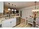 Open concept kitchen with modern appliances, stylish lighting, and views into the cozy living room at 505 Gooseneck Dr # B1, Cary, NC 27513