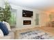 Bright living room featuring a modern fireplace, large screen TV, and views to the backyard at 505 Gooseneck Dr # B1, Cary, NC 27513