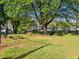 Community picnic area with mature trees, grassy lawn and a grill at 505 Gooseneck Dr # B1, Cary, NC 27513
