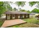 Charming brick home featuring a spacious wooden deck and a playset for in the backyard at 508 Solar Dr, Raleigh, NC 27610