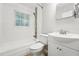 Clean bathroom featuring a sink, vanity, tiled shower, and a window for natural light at 508 Solar Dr, Raleigh, NC 27610