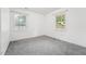 Neutral bedroom featuring plush carpet, white walls and two windows at 508 Solar Dr, Raleigh, NC 27610
