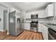 Well-appointed kitchen with stainless steel appliances, granite countertops, and white cabinets, perfect for cooking at 508 Solar Dr, Raleigh, NC 27610