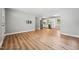 Open-concept living space with wood floors, flowing seamlessly into a modern, updated kitchen at 508 Solar Dr, Raleigh, NC 27610
