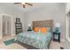 Bright bedroom featuring a ceiling fan and a large bed with side tables and lamps at 511 Hillsborough St # 103, Chapel Hill, NC 27514
