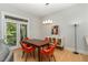 Bright dining area featuring modern light fixture, stylish sideboard, and adjacent outdoor access at 511 Hillsborough St # 103, Chapel Hill, NC 27514
