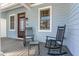 Inviting front porch with rocking chairs, perfect for enjoying the outdoors and a neighborhood setting at 511 Hillsborough St # 103, Chapel Hill, NC 27514