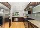 Gourmet kitchen featuring granite countertops, stainless steel appliances, and dark wood cabinets at 511 Hillsborough St # 103, Chapel Hill, NC 27514